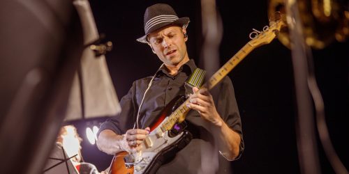 handsome-man-playing-guitar-at-night-outdoor-concert-scaled-1.jpg handsome-man-playing-guitar-at-night-outdoor-concert-scaled-1.jpg